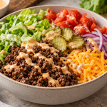 Cheeseburger bowl with ground beef, lettuce, tomato, pickles, cheddar and burger sauce