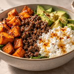Ground beef bowl with roasted sweet potatoes, cottage cheese, avocado and hot honey